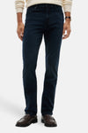 Dark blue straight-leg denim jeans with slim fit, worn by model in front view, paired with cream sweater and brown loafers