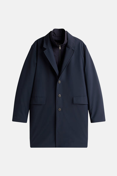 Lange blauwe jas van TOMMY HILFIGER met knoopsluiting en opgestikte zakken.