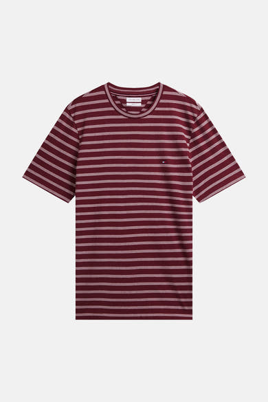 Burgundy short-sleeve t-shirt with white horizontal stripes by Tommy Hilfiger, featuring a round neckline and small flag logo on chest, front view.