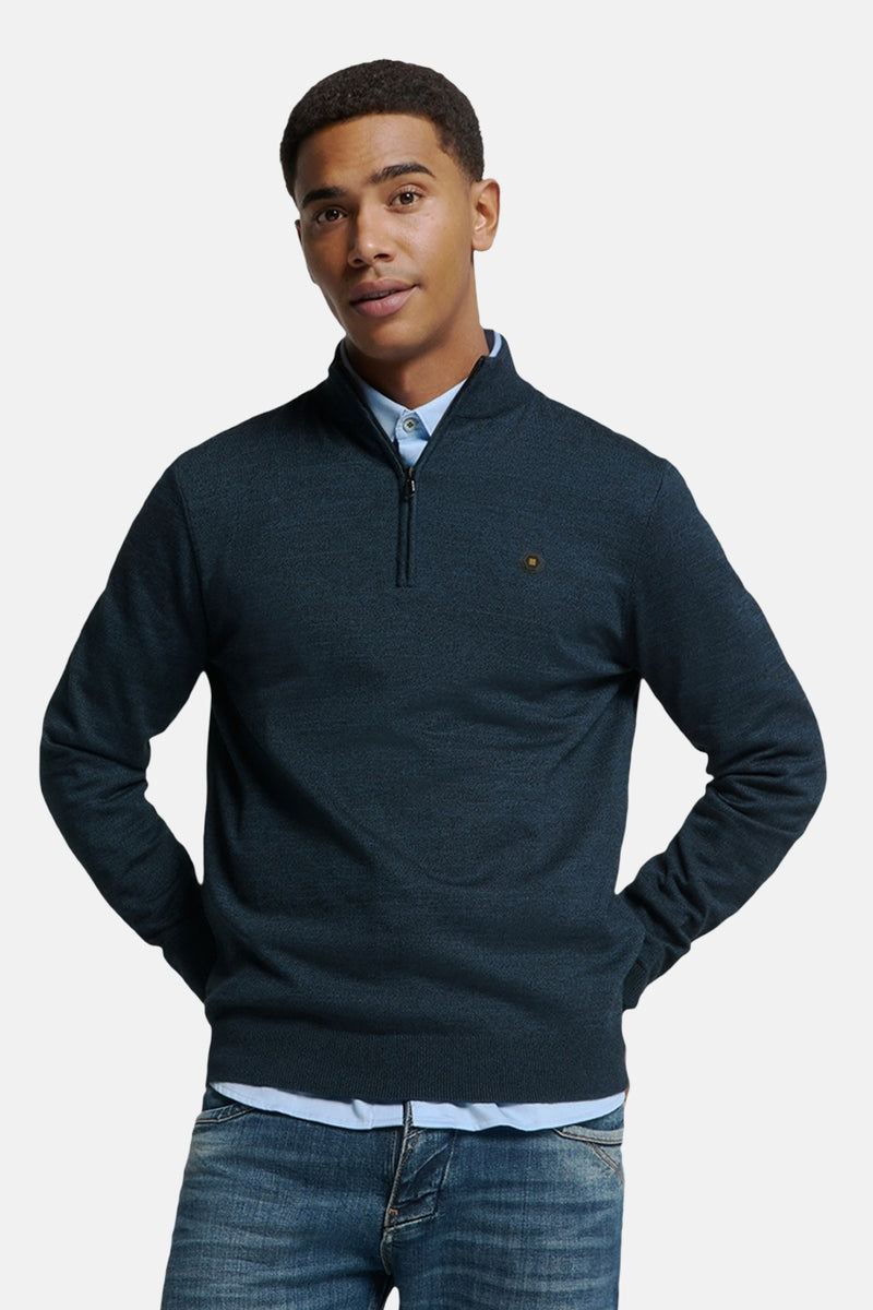 Pull à col roulé bleu de NO EXCESS, porté sur une chemise bleu clair et un jean.