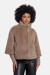 Taupe faux fur casual jacket by RINO PELLE, featuring a high collar and relaxed fit, worn with ribbed sleeves and black leather pants.