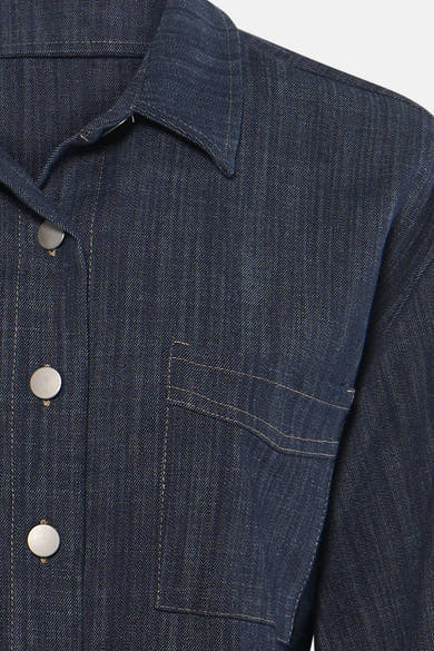 Chemise en denim bleu foncé à manches longues par AMELIE ET AMELIE, avec col classique, boutons métalliques et poche plaquée, vue rapprochée.