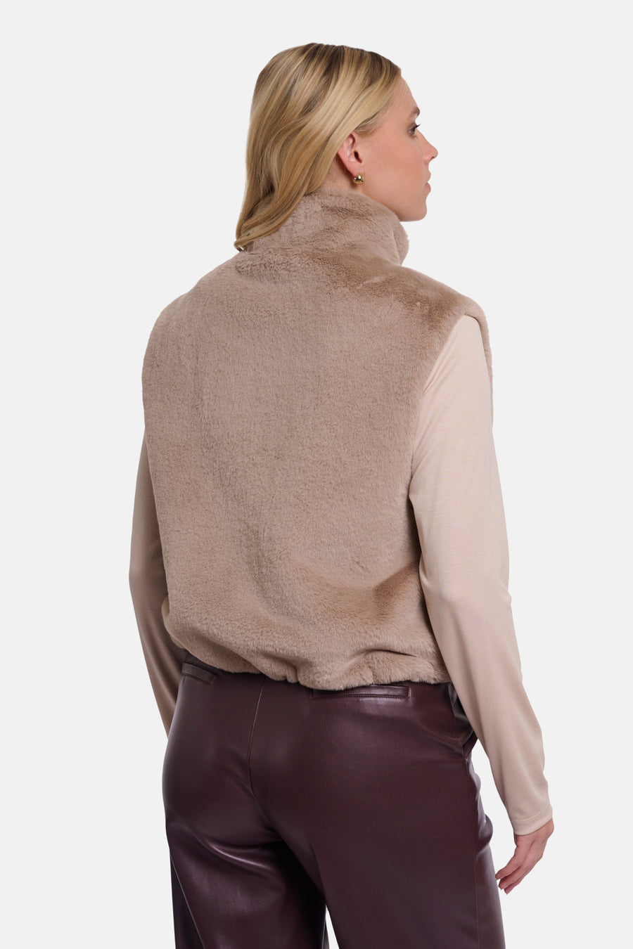 Beige faux fur bodywarmer by RINO PELLE, back view, high collar, soft texture, worn with cream top and burgundy leather pants