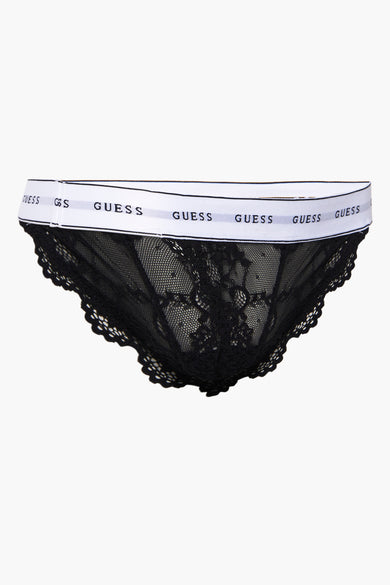 Slip noir en dentelle de Guess, avec une ceinture élastique blanche siglée du nom de la marque.