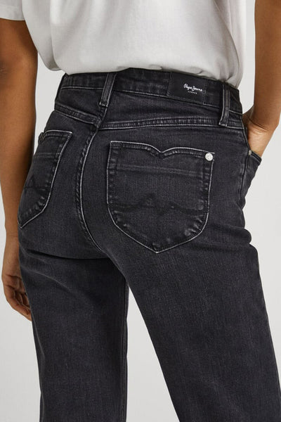 Dark blue flared jeans by Papa Jeans, back view with white stitching and classic five-pocket design, worn with a white top.