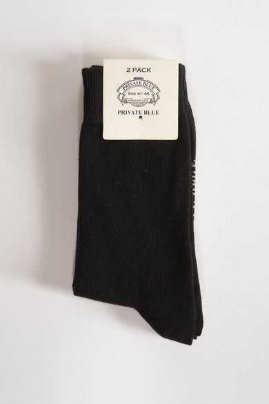 Paire de chaussettes noires de PRIVATE BLUE, présentées avec leur emballage cartonné.
