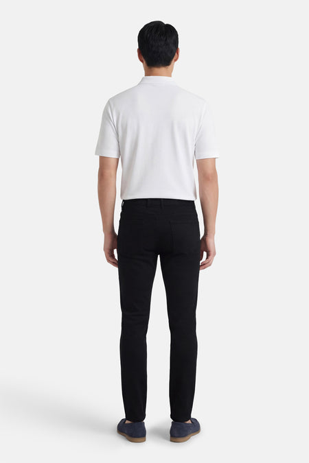 Zwarte broek van PRIVATE BLUE, gedragen met een witte polo en blauwe loafers, achtergezicht.