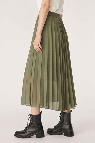 Olive green pleated 3/4 length skirt with sheer overlay, worn with black combat boots, side view.