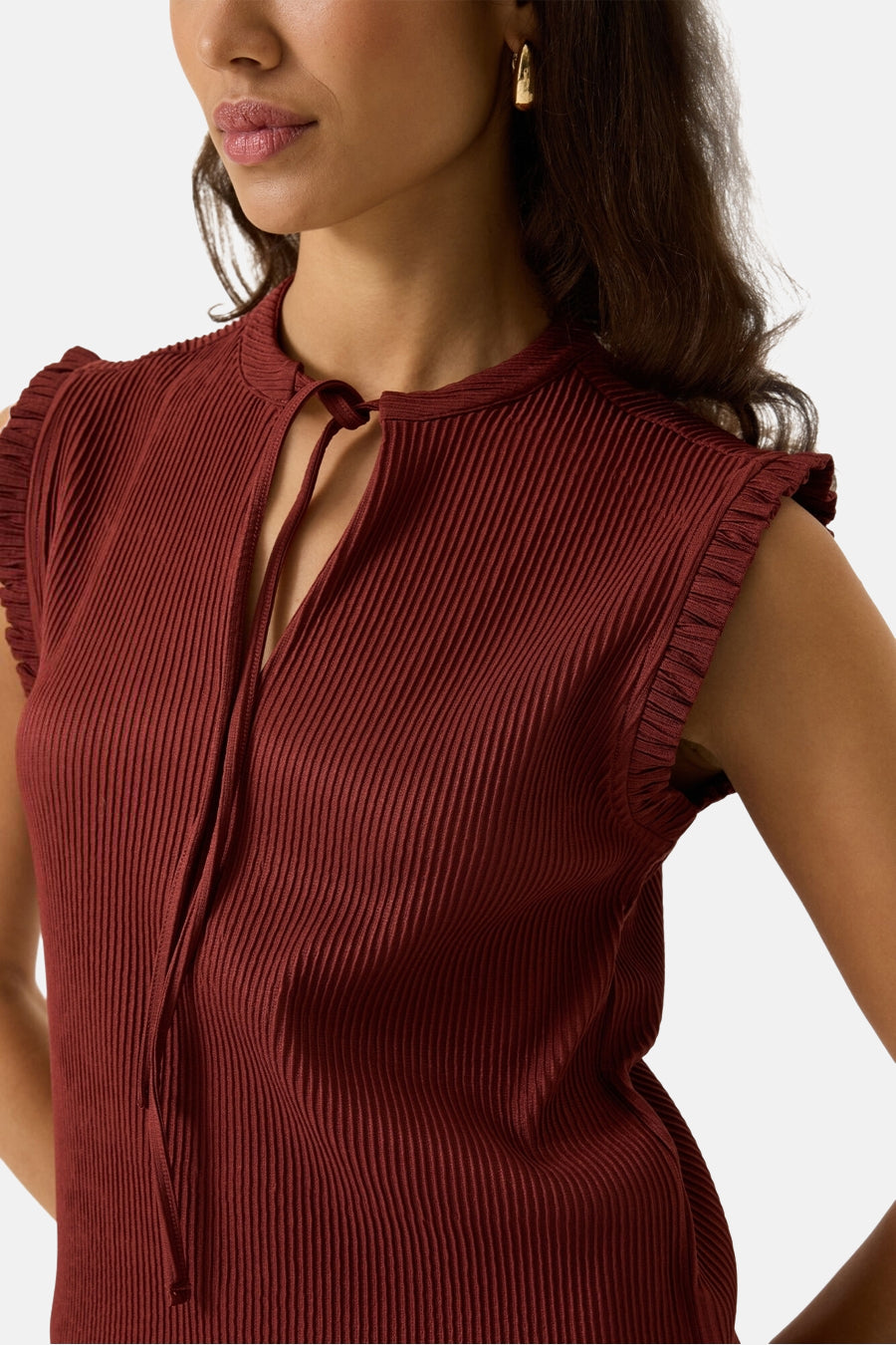 Terracotta ribbed sleeveless blouse with ruffled shoulders and front tie neck, cropped front view