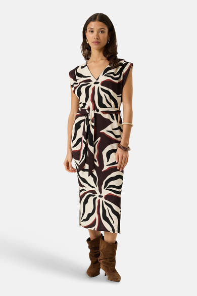 Multicolored sleeveless dress with bold leaf pattern and tie waist, front view, worn with brown boots
