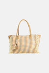 Sac à bandoulière beige de Access® en raphia tressé avec motif à picots crème, franges et breloque décorative.