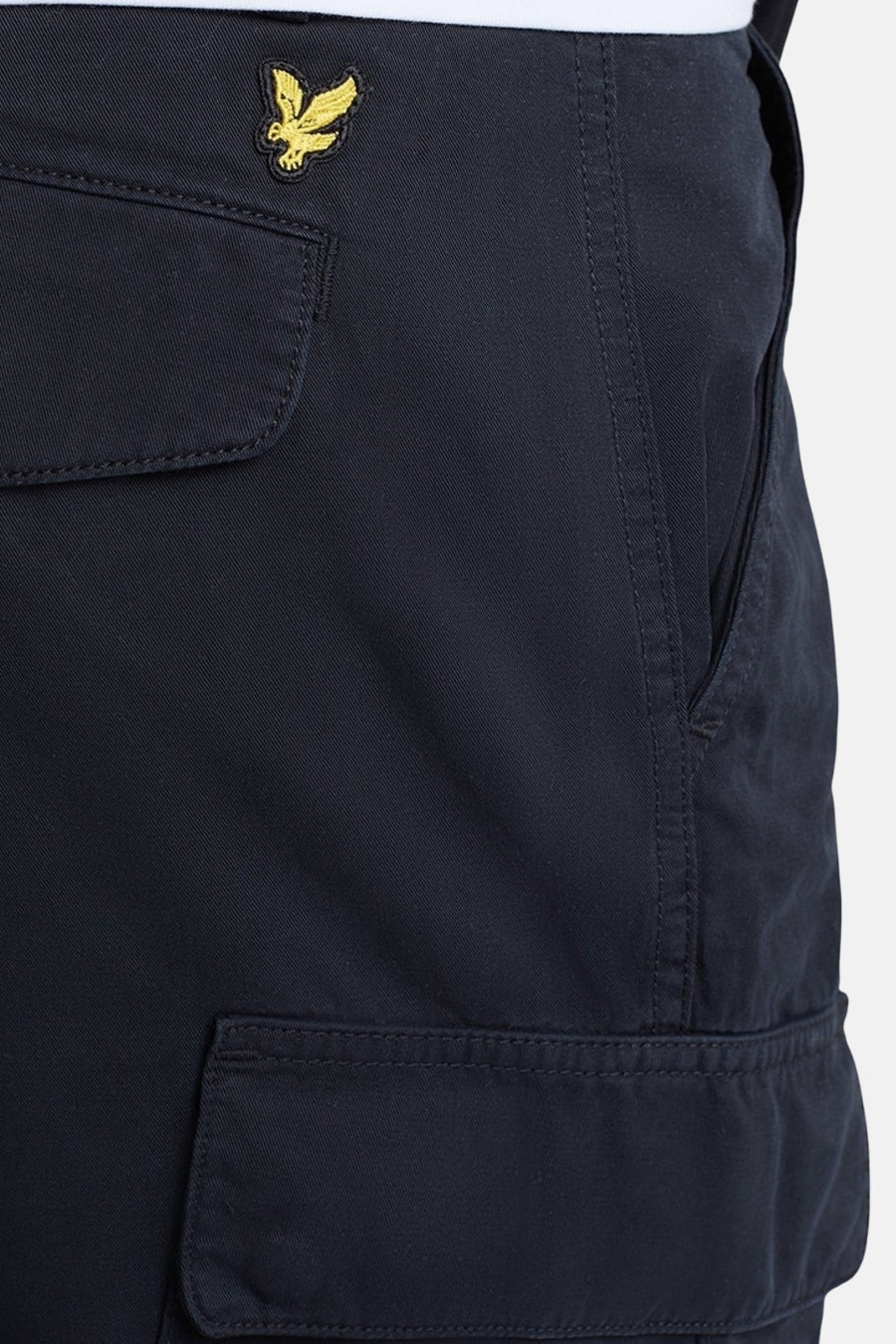 Short bleu de LYLE & SCOTT, avec poches cargo et logo doré, détail de couture visible.