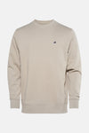 Beige sweater van STROM, met een klein logo op de borst.