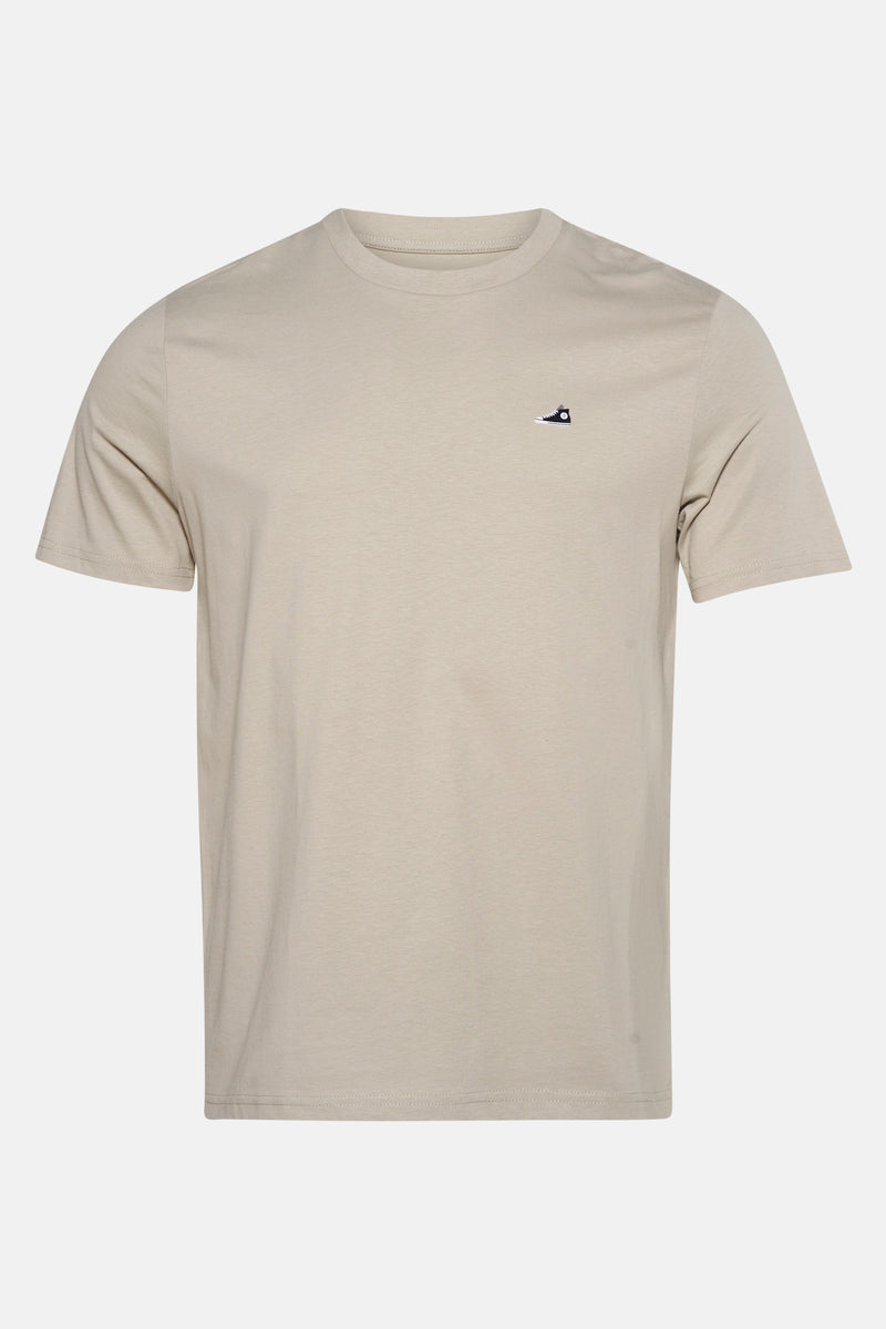 T-shirt à manches courtes beige de STROM, avec un logo discret en forme de chaussure.