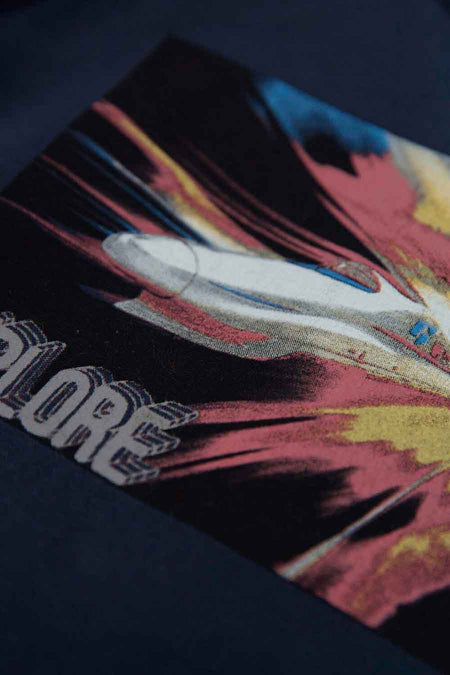 Blue long-sleeve t-shirt with vibrant rocket graphic and bold "EXPLORE" text, close-up front view