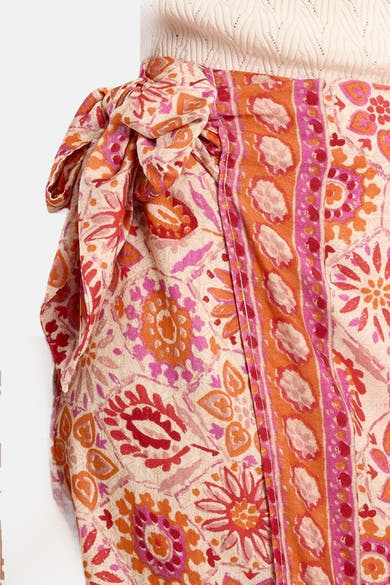 Jupe longue multicolore par Molly Bracken, ornée d'un motif floral et nouée sur le côté.