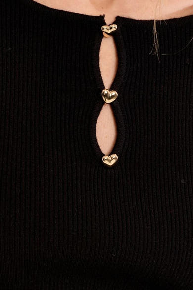Black ribbed O-neck sweater with vertical keyhole and gold heart-shaped buttons, close-up front view