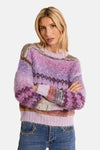 Multicolored fuzzy knit O-neck sweater with geometric patterns and ribbed hem, worn with studded jeans in front view