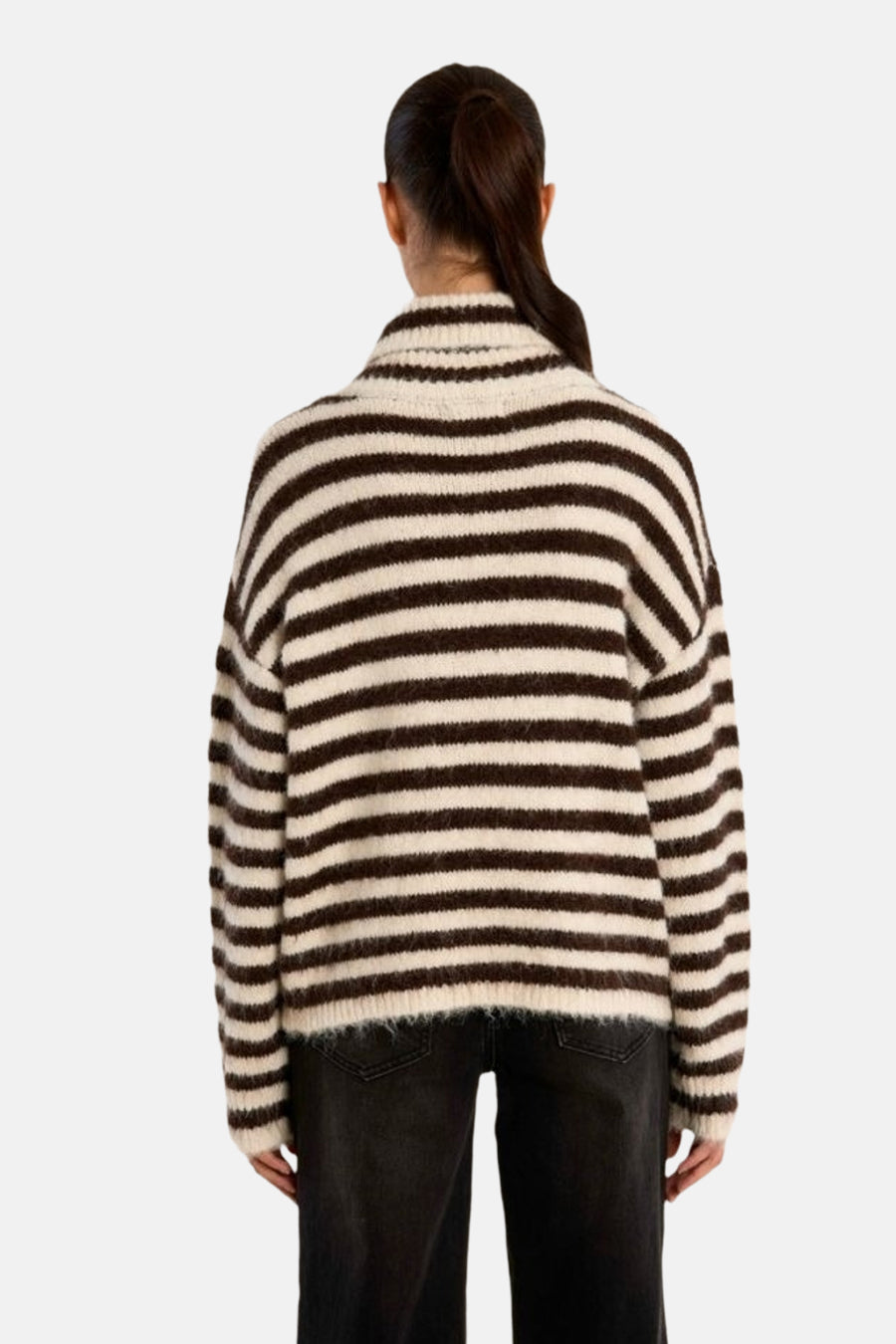 Multicolored striped turtleneck sweater with ribbed collar and cuffs, back view, worn with dark jeans