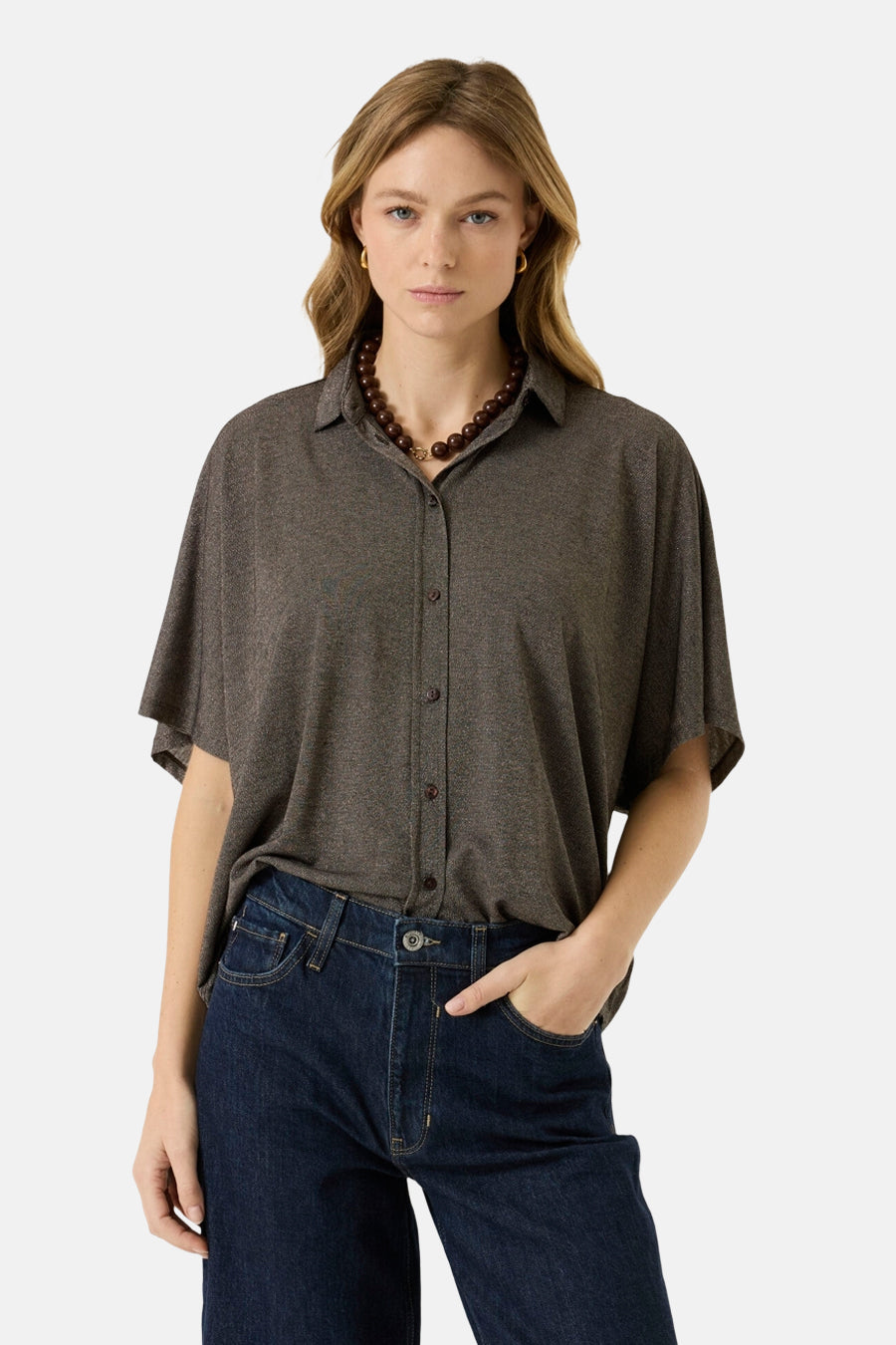 Brown 3/4 sleeve blouse with button front and relaxed fit, worn with dark jeans and beaded necklace, front view