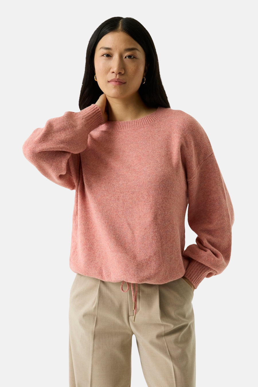 Coral crewneck sweater with soft textured knit, relaxed fit, and ribbed cuffs, worn with beige pants in front view