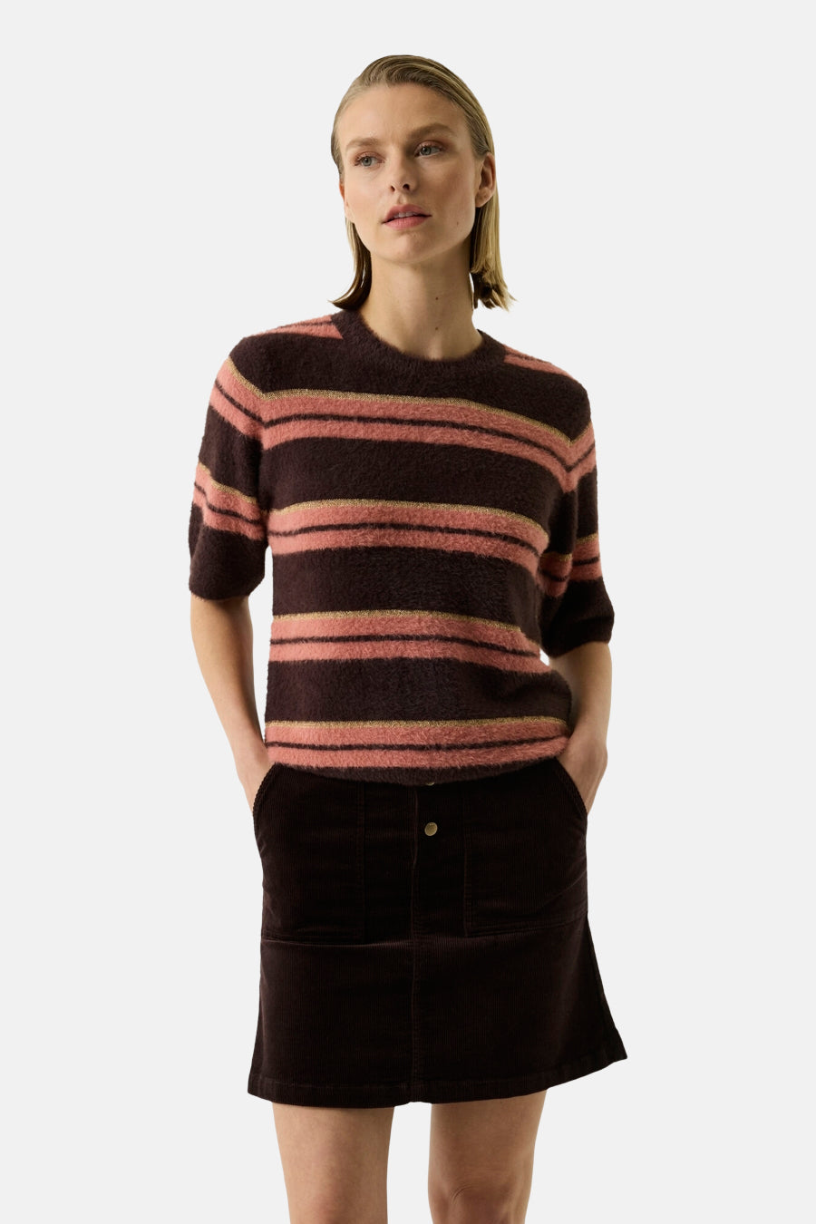 Multicolored striped O-neck sweater with soft textured knit, worn with dark corduroy skirt, front view