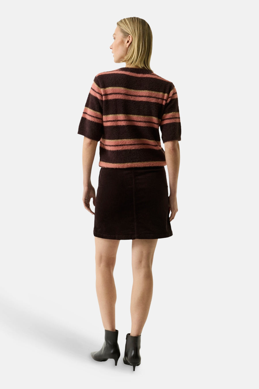 Multicolored striped O-neck sweater with short sleeves, back view, worn with dark skirt and black ankle boots