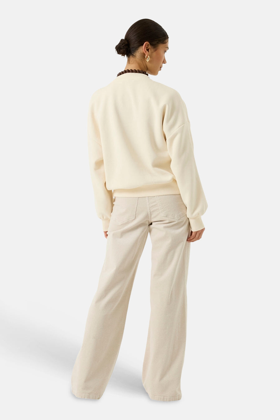Ecru crewneck sweatshirt with ribbed cuffs and hem, back view, paired with matching wide-leg pants