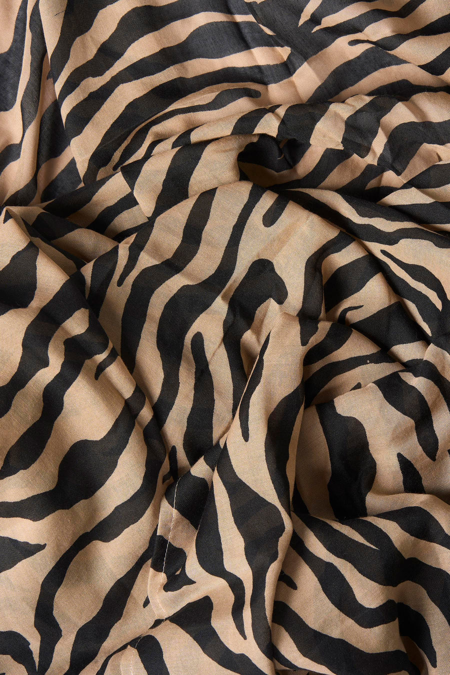Brown foulard with black zebra print, soft lightweight fabric, close-up texture view