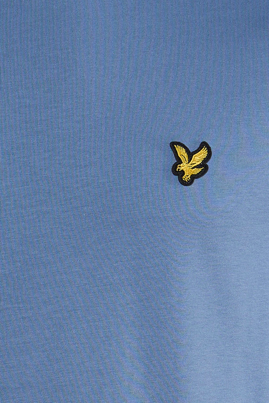 Blue short-sleeve t-shirt with golden eagle embroidery on chest, close-up view