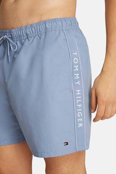 Blauwe zwembroek van TOMMY HILFIGER met trekkoord en merklogo aan de zijkant.