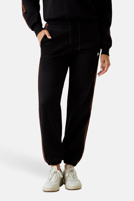 Zwarte joggingbroek van Guess met bruine bies aan de zijkant en trekkoord.