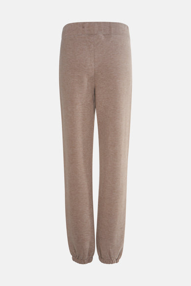 Beige joggingbroek van Guess, met een geribbelde textuur en elastische enkels, op een effen achtergrond.