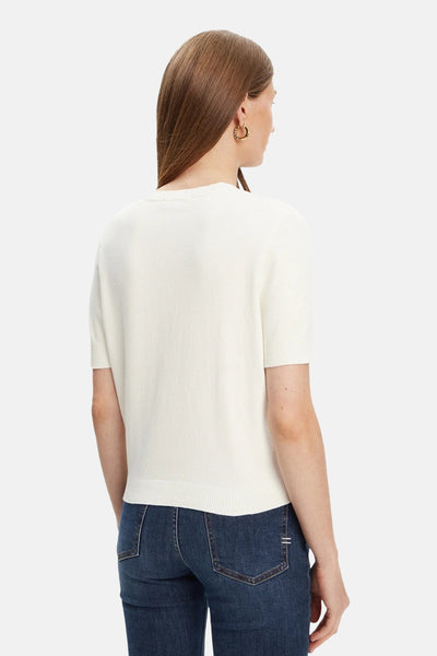 Pull écru à col rond de Guess, porté avec un jean bleu foncé, vue de dos.