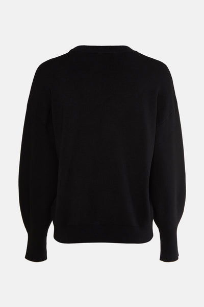 Pull noir à col rond de Guess, avec manches bouffantes et texture tricotée.