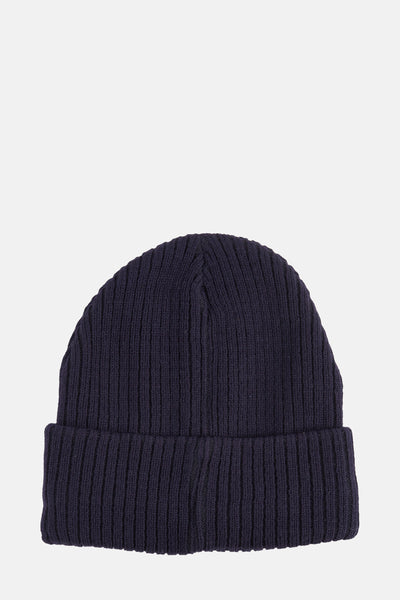 Bonnet bleu marine de DODI, en tricot côtelé avec revers, sur fond neutre.
