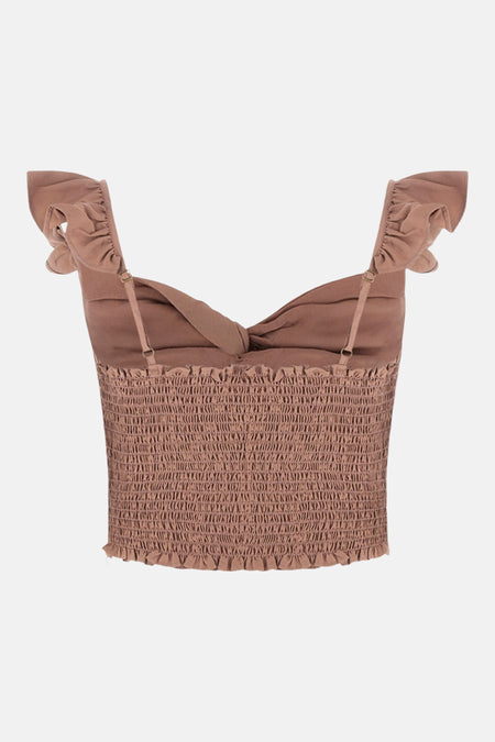Débardeur rose Guess, à smocks et bretelles fines, agrémenté de volants aux épaules.
