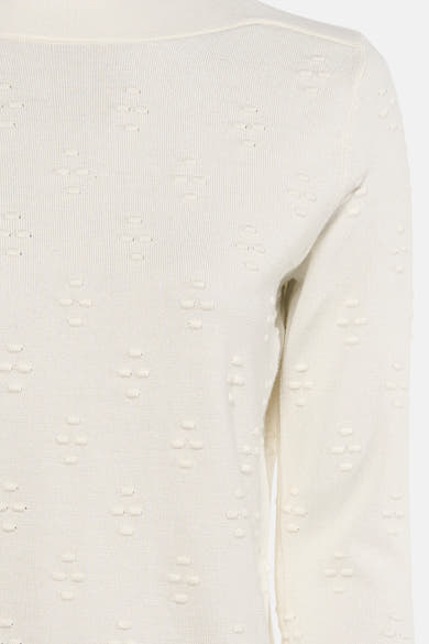 Pull à col rond écru de Zabaione, avec un motif en croix en relief et une texture tricotée.