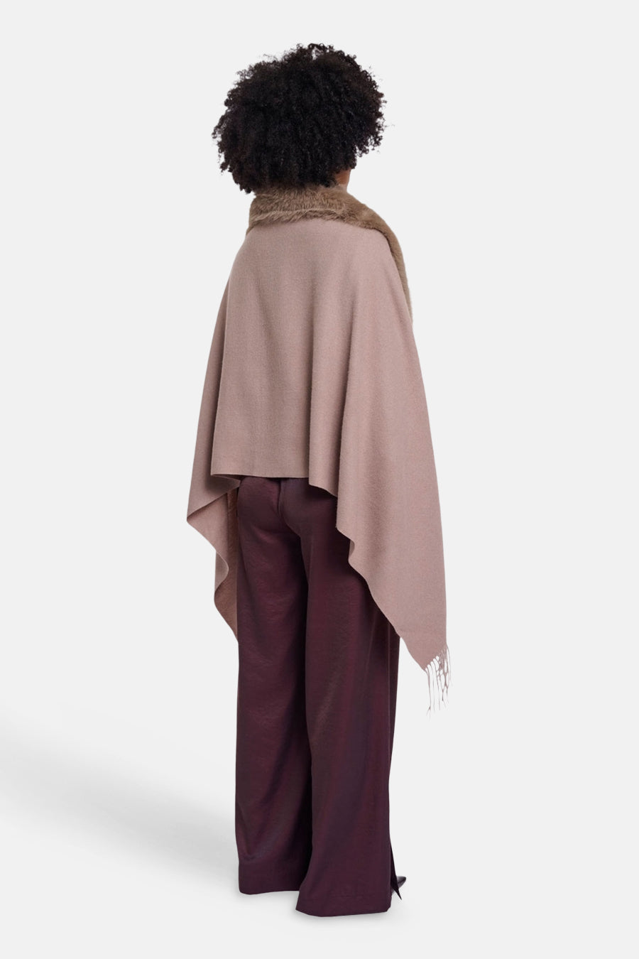 Beige wool scarf with fringe, back view on model wearing burgundy wide-leg pants