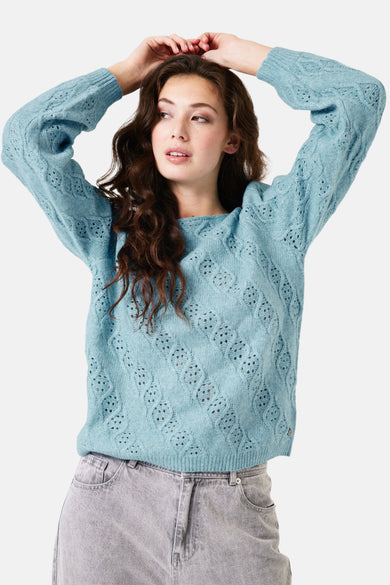 Pull bleu à col rond de GARCIA, avec motif ajouré, porté avec un jean gris.