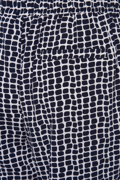 Pantalon multicolore de ZABAIONE avec un motif géométrique de carreaux et une poche plaquée visible.
