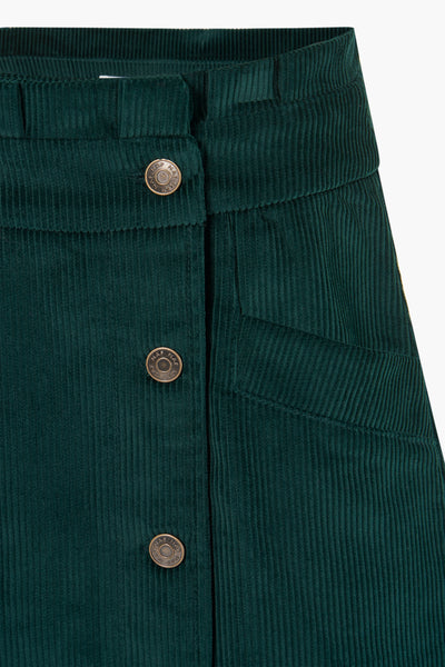 Dark green corduroy midi skirt by NAF NAF, featuring front button closure and side pocket, close-up view.