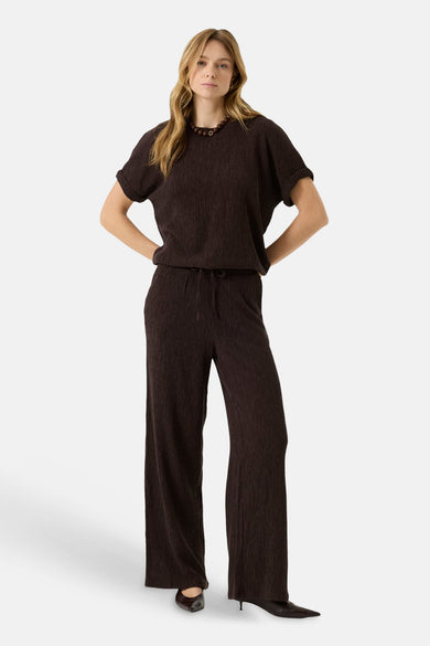 Brown ribbed knit wide-leg pants with elastic waist and drawstring, full-length front view on model wearing matching top and black heels