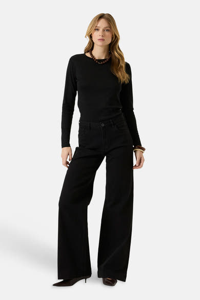 Black long-sleeve t-shirt with ribbed texture and round neckline, worn with black wide-leg pants and brown beaded necklace, full-length front view