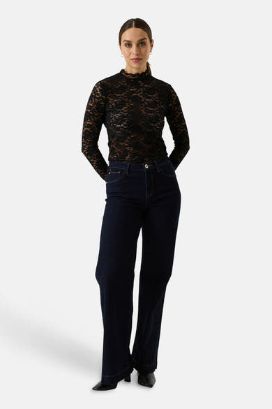 Black long-sleeve lace top with high neckline, worn with dark jeans and black boots, full-length front view