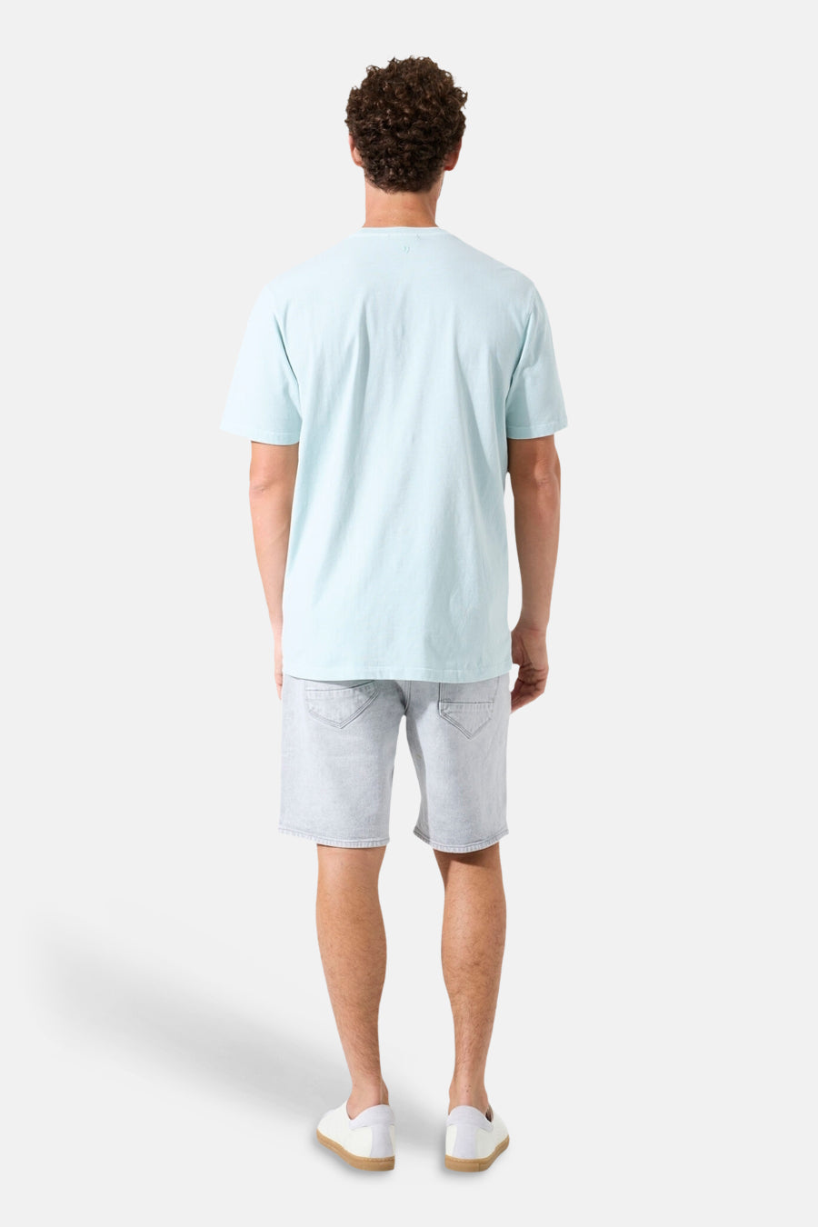 T-shirt vert clair de GARCIA, vu de dos, porté avec un short en jean et des chaussures blanches.
