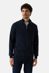 Navy blue half-zip sweater with ribbed cuffs and hem, worn by model in front view, paired with dark jeans
