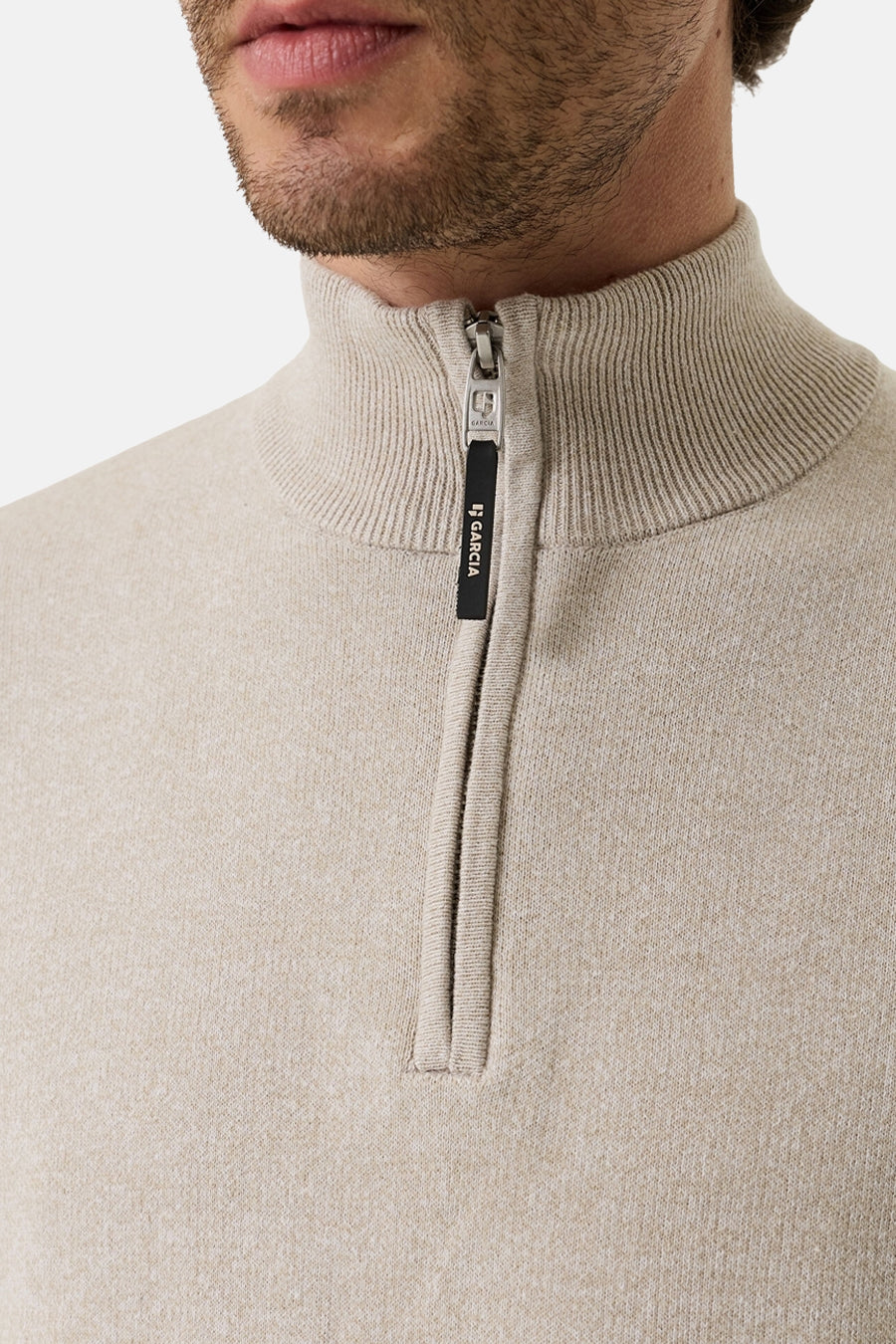 Beige ribbed knit half-zip sweater by Garcia, featuring a stand-up collar and black zipper pull with brand logo, close-up front view